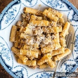 Pasta alla Montecarlo in a blue and white bowl topped with Parmigiano Reggiano.