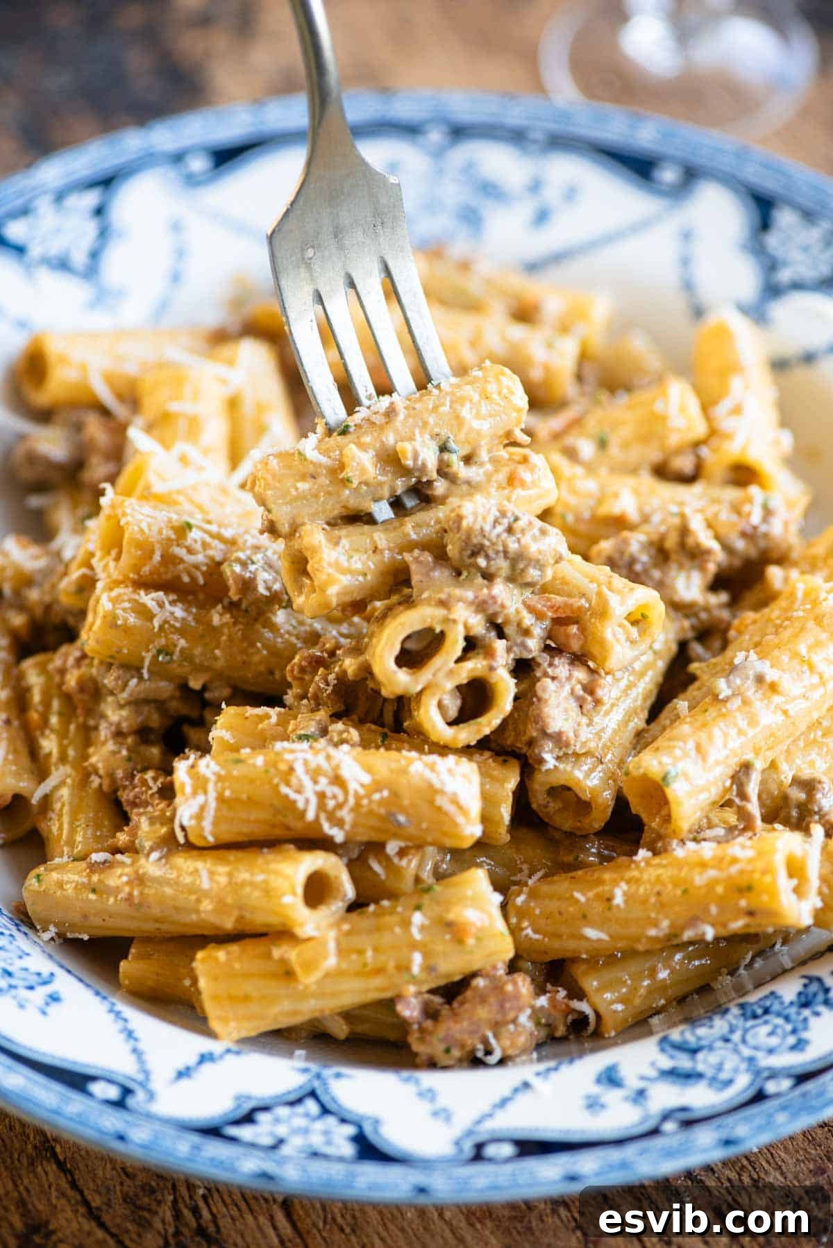 A mouthwatering close-up of a fork artfully twirling a bite of Pasta alla Montecarlo, showcasing the rich, creamy meat sauce clinging perfectly to the pasta strands.