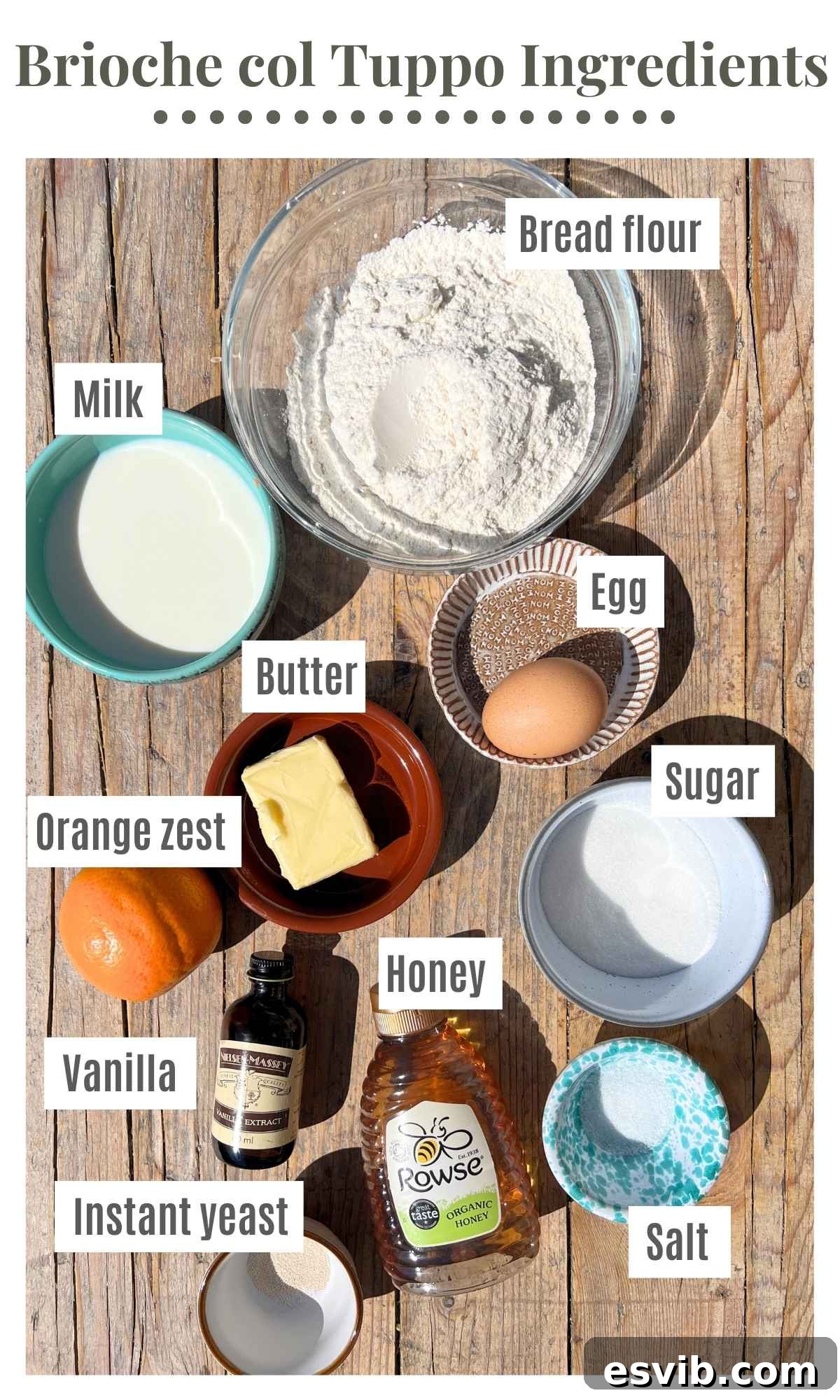 All the essential ingredients neatly laid out on a rustic wooden surface, showcasing everything needed to bake a batch of delicious Sicilian brioche buns, from flour and butter to eggs and orange zest.