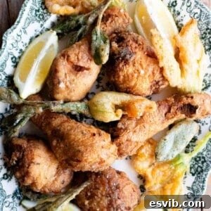 A close-up of beautifully fried chicken on a serving platter, highlighting its golden, crispy texture.