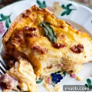 A mouthwatering baked butternut squash lasagna, topped with golden cheese and herbs, ready to be served.
