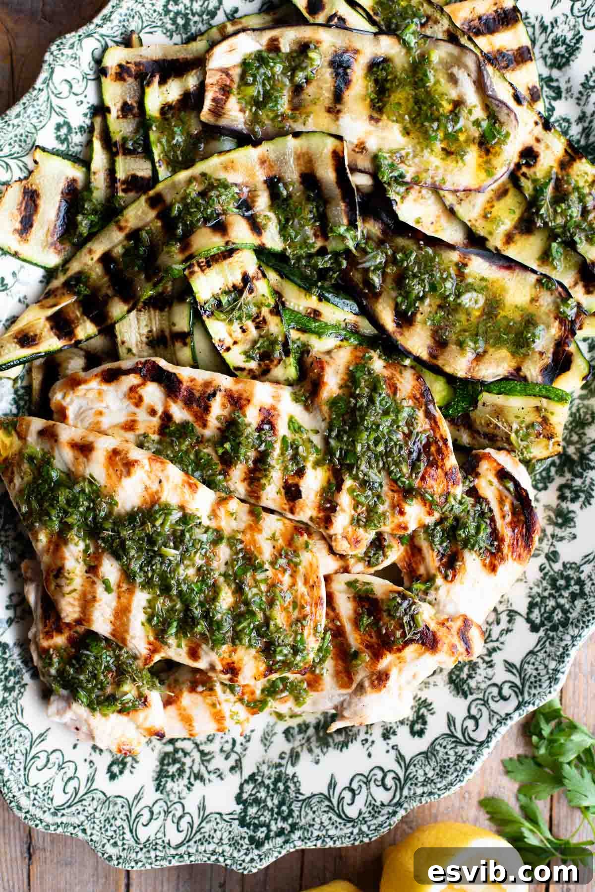 Salmoriglio: Zesty Southern Italian Herb Sauce 2 Grilled chicken and vegetables on a platter with Salmoriglio sauce drizzled over the top.