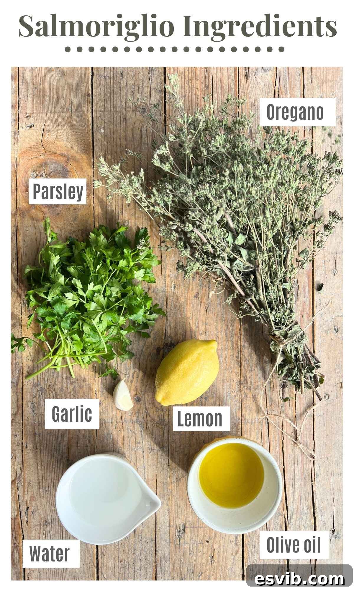 Salmoriglio: Zesty Southern Italian Herb Sauce 3 Dried oregano, fresh parsley, extra virgin olive oil, a whole lemon, garlic cloves, and a small bowl of water laying on a wooden surface, ready for Salmoriglio preparation.