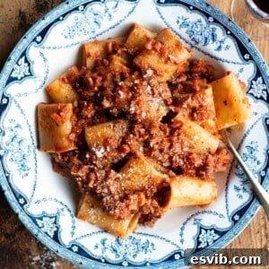 A close up of hazelnut ragu and paccheri pasta in a blue and white vintage style bowl.