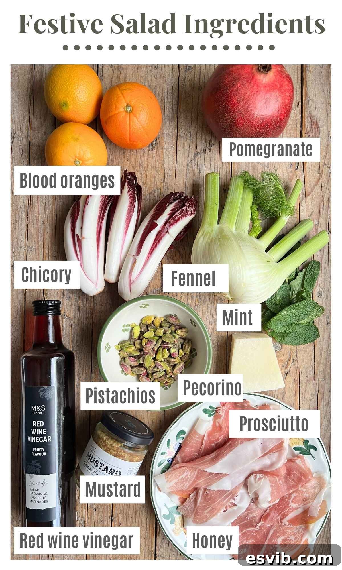 All the ingredients for a festive salad laying on a rustic wooden surface. The labels read: blood oranges, pomegranate, fennel, chicory, red wine vinegar, mustard, mint, honey, prosciutto, pistachios and pecorino.