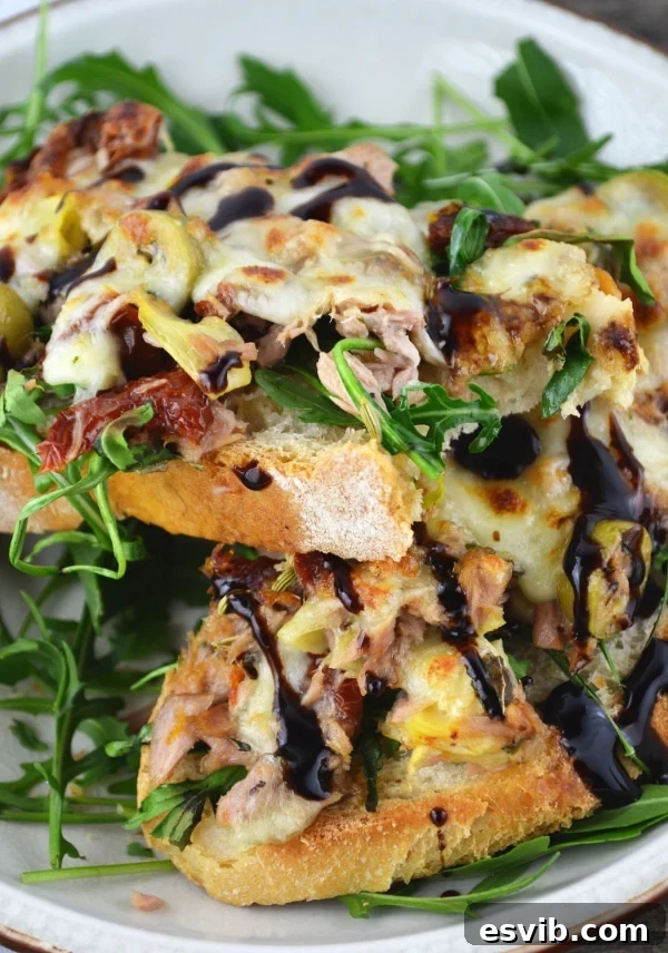 Two Mediterranean tuna melts ready to be served, garnished with balsamic glaze