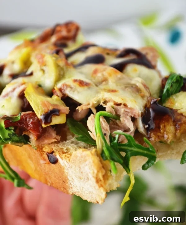 Close-up of a Mediterranean tuna melt with a side salad for a complete meal