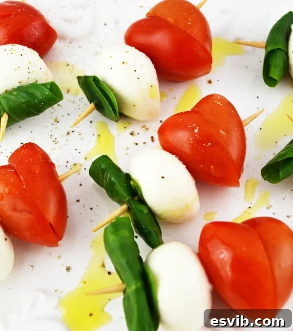 Simple Valentine's Caprese Skewers recipe with heart-shaped tomatoes. www.insidetherustickitchen.com
