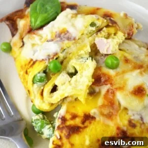 Final plated image of Crespelle with ricotta, peas, ham, and a creamy Fontina cheese sauce