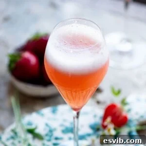 A close up cropped image of a beautifully vibrant Rossini cocktail, highlighting its color and freshness.