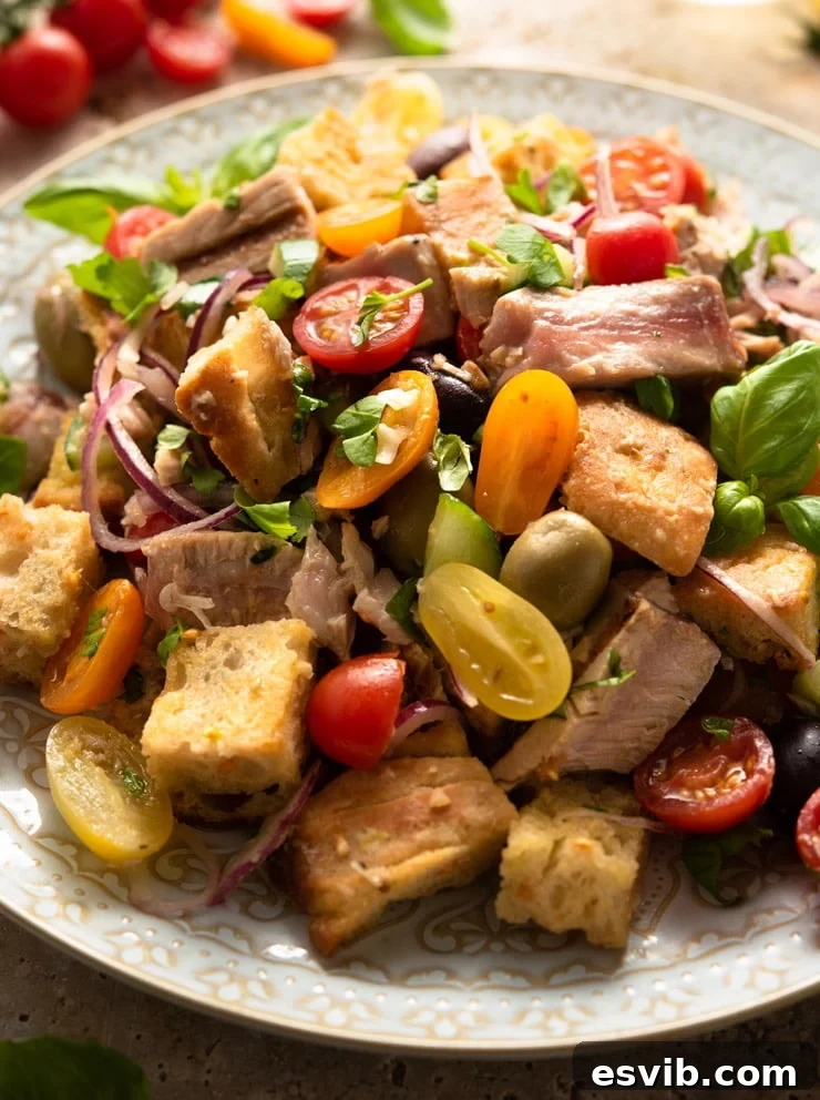 A close up of a tuna panzanella salad on a large serving plate