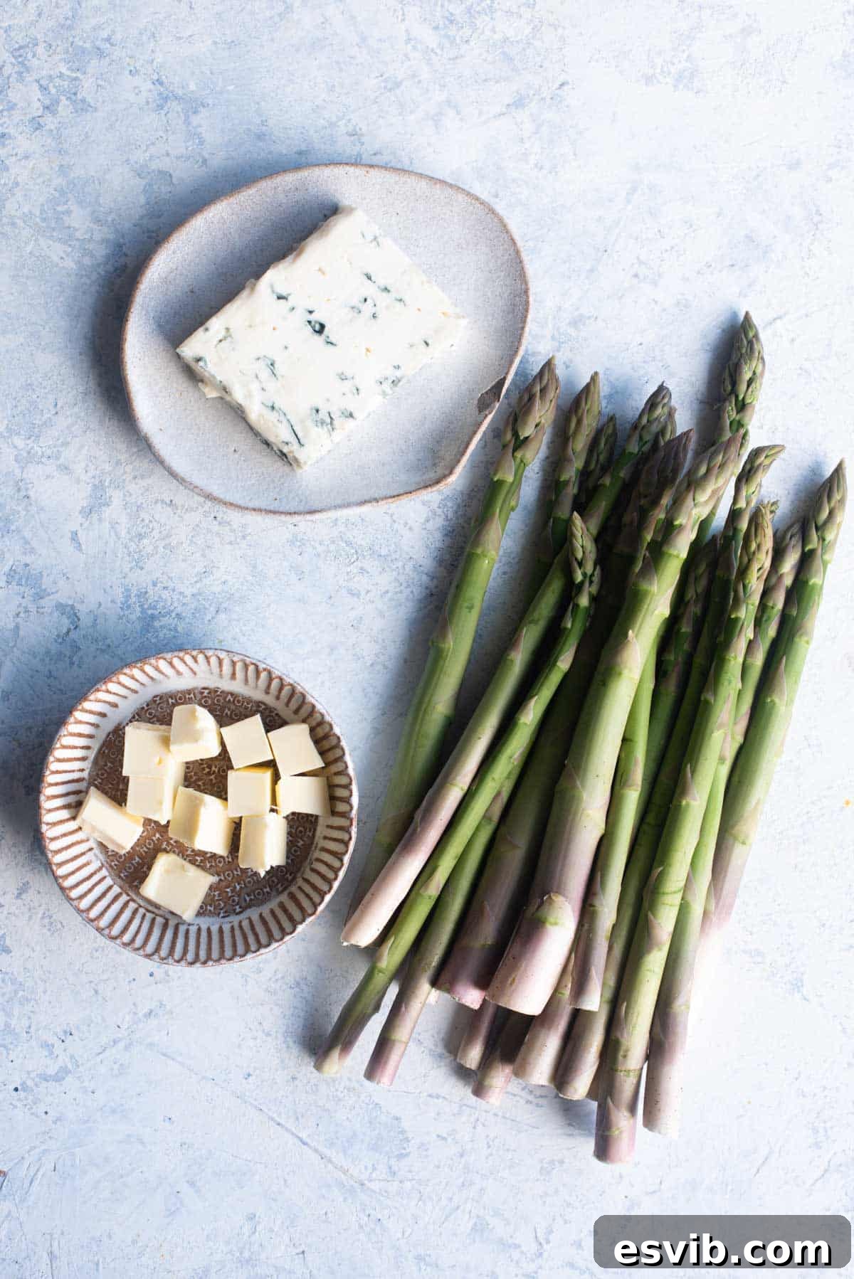An overhead shot displaying all the fresh and simple ingredients needed to create Gorgonzola roasted asparagus.