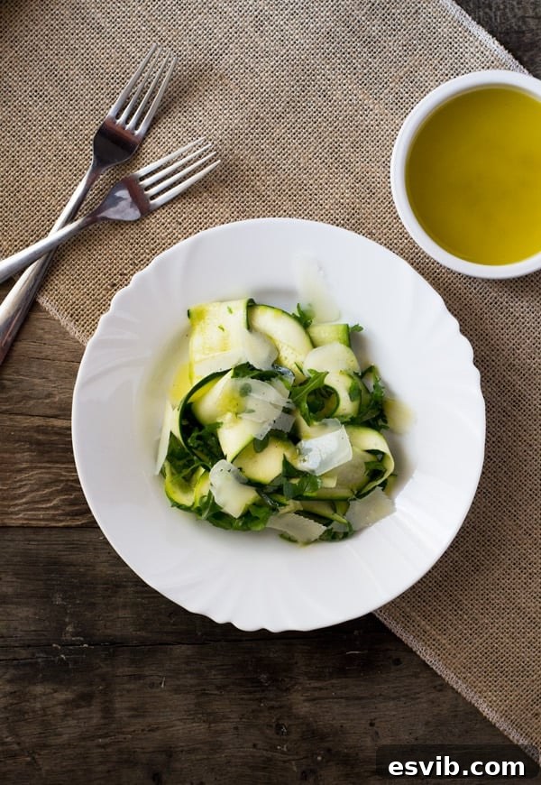 Shaved Zucchini Salad 3 Vibrant Zucchini Ribbon Salad with lemon dressing, arugula, and parmesan shavings, ready to be served.
