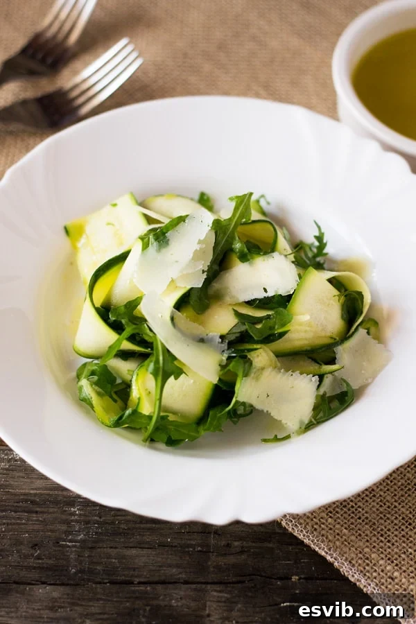 Shaved Zucchini Salad 4 Chef's hands preparing thin zucchini ribbons with a mandoline slicer for a fresh summer salad.