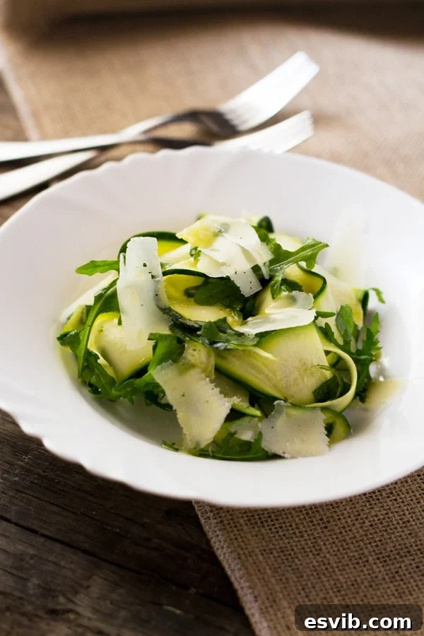 Shaved Zucchini Salad 6 A close-up shot of the finished Zucchini Ribbon Salad, garnished with fresh basil leaves and parmesan, ready for enjoyment.