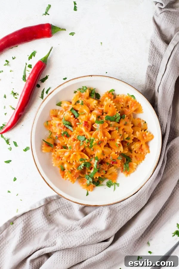 A delicious and simple farfalle pasta with pancetta recipe with fresh chili, garlic and a dash of cream. This simple pasta dish makes a great quick weeknight meal that's delicious eaten hot or cold. Italian pasta recipes insidetherustickitchen Farfalle pasta with crispy pancetta, fresh red chili, and garlic in a creamy tomato sauce, perfect for a quick and easy Italian weeknight meal.