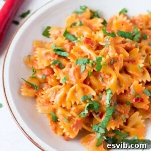 Spicy Garlic Farfalle with Crispy Pancetta 3 A vibrant bowl of farfalle pasta with crispy pancetta, red chili, and a creamy tomato sauce.