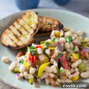 A warm easy bean salad recipe with yellow pepper, eggplant, tomatoes, garlic and delicious fresh herbs.