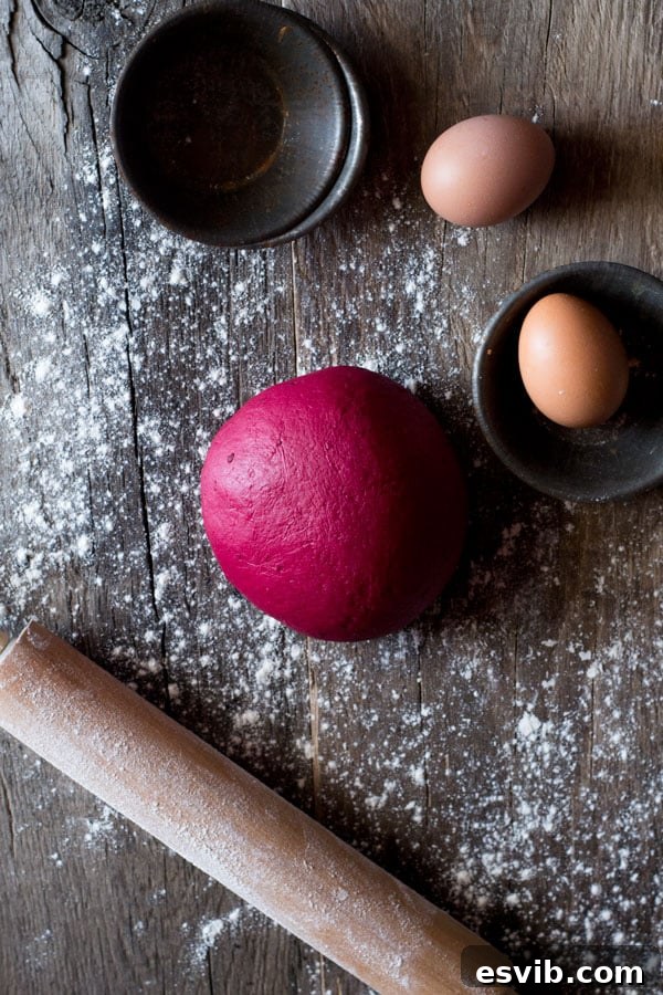 Learn to make easy, fun, and vibrant bright pink beetroot pasta. Bright pink homemade beetroot pasta dough ready to be shaped.