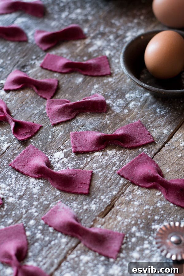 The perfect smooth texture of beetroot pasta dough. Close-up of vibrant pink beetroot pasta dough, kneaded and ready.