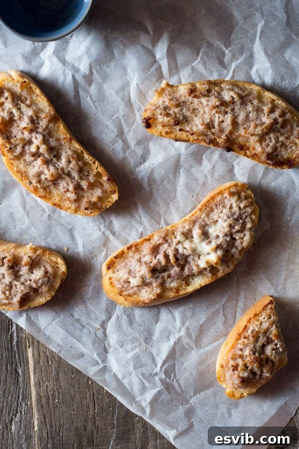 Close-up of baked Stracchino and Italian Sausage Crostini, golden brown and melted