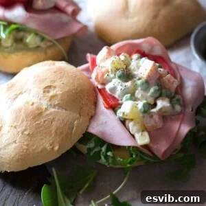 A close up of Russian salad on a roll
