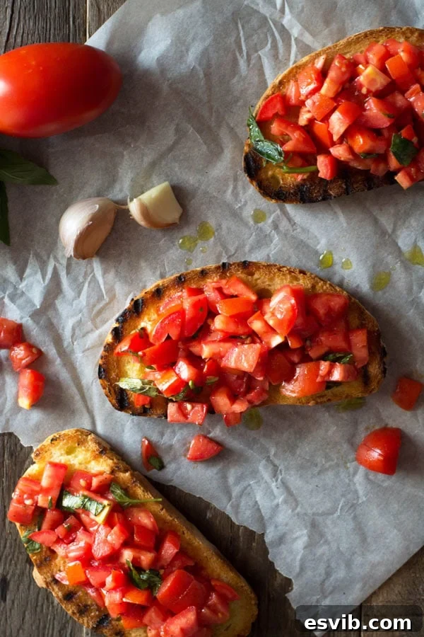 A beautifully composed serving of three slices of Bruschetta al Pomodoro, showcasing perfectly char-grilled crusty bread topped with a vibrant mixture of chopped fresh tomatoes and basil, arranged on a wooden surface.