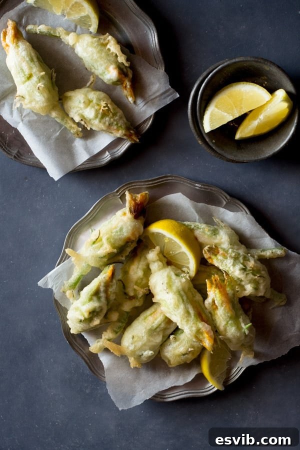 Crispy fried zucchini flowers stuffed with ricotta, chili flakes and lemon inside a rustic kitchen