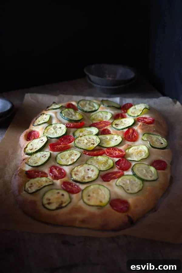 Delicious zucchini tomato focaccia. A simple Italian snack or appetizer with a crispy crust and soft, light and fluffy middle. Authentic Italian recipes and traditional Italian recipes at Inside the rustic kitchen. Delicious zucchini tomato focaccia. A simple Italian snack or appetizer with a crispy crust and soft, light and fluffy middle. Authentic Italian recipes and traditional Italian recipes at Inside the rustic kitchen.