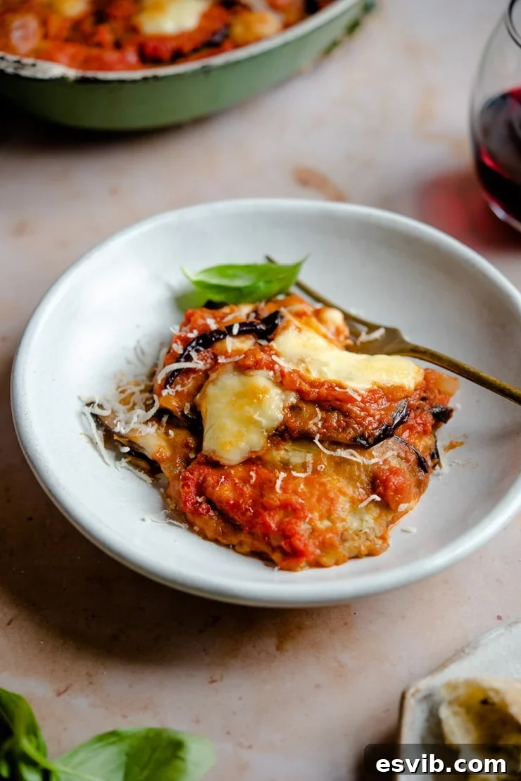 Eggplant parmigiana in a bowl with a fork