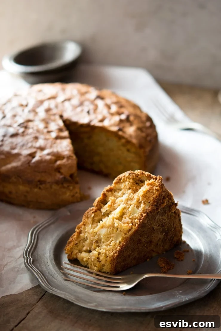 Thick and rich apple olive oil cake batter being prepared with fresh apples and golden sultanas