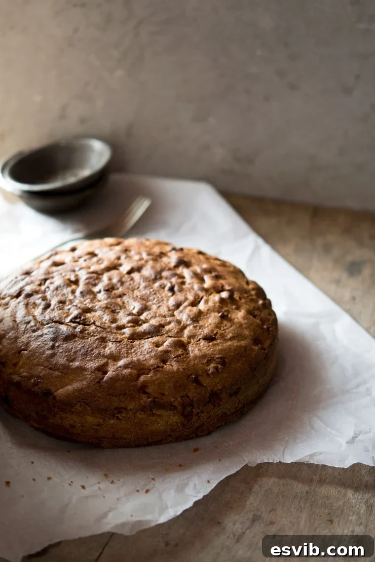 Freshly baked Apple Olive Oil Cake cooling on a wire rack, ready to be served