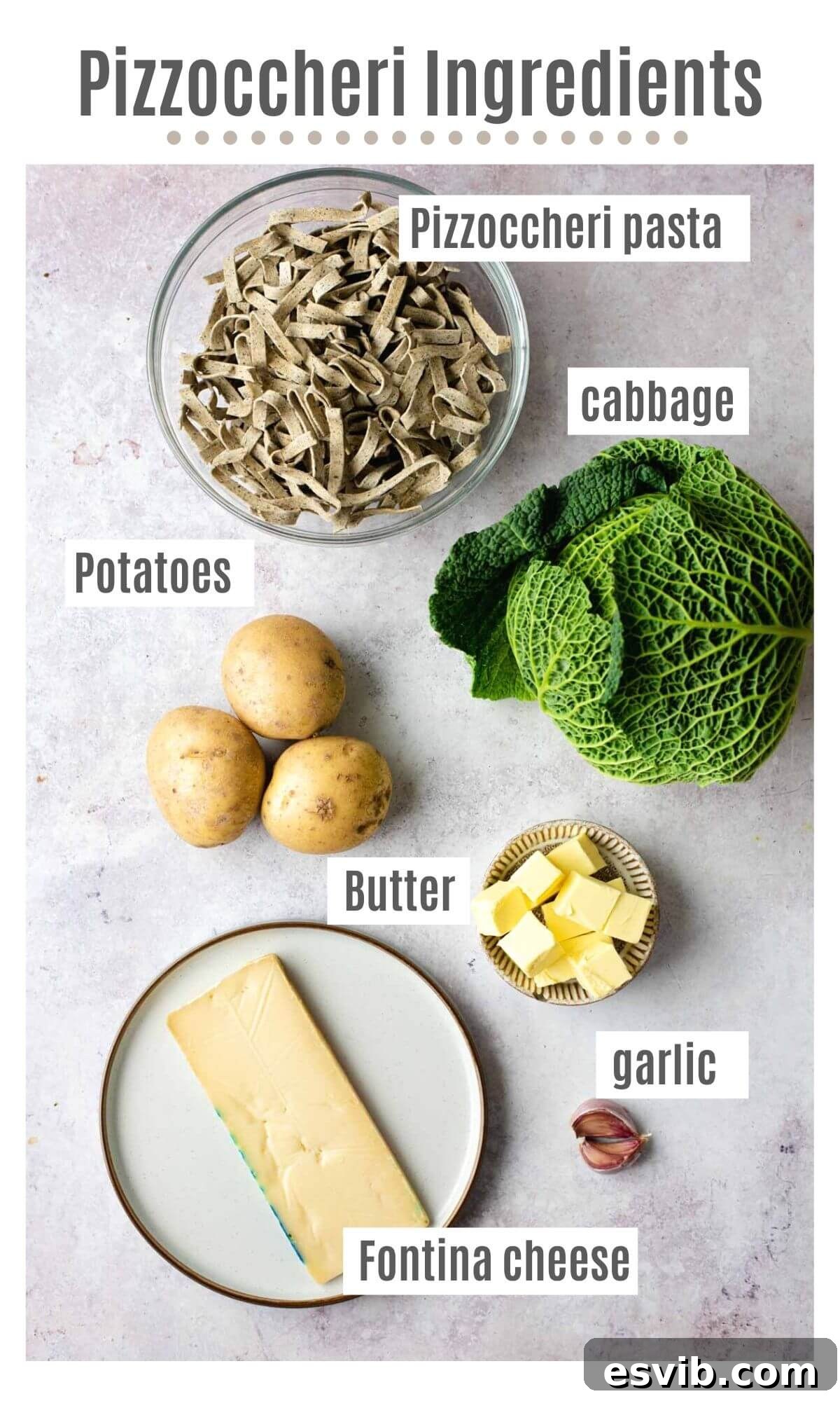An overhead shot of all the fresh ingredients required to make Pizzoccheri pasta with potatoes and cabbage, neatly arranged