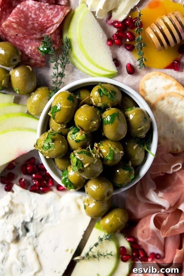 A close up of marinated olives in a ramekin A close-up shot of vibrant green and black marinated olives glistening in olive oil within a white ramekin, ready to be served.