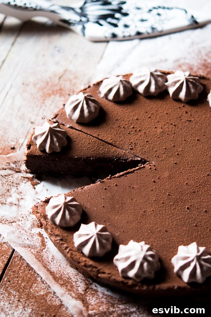 A perfectly cut slice of no-bake chocolate cheesecake resting on a rustic wooden surface, showcasing its rich layers and creamy texture.