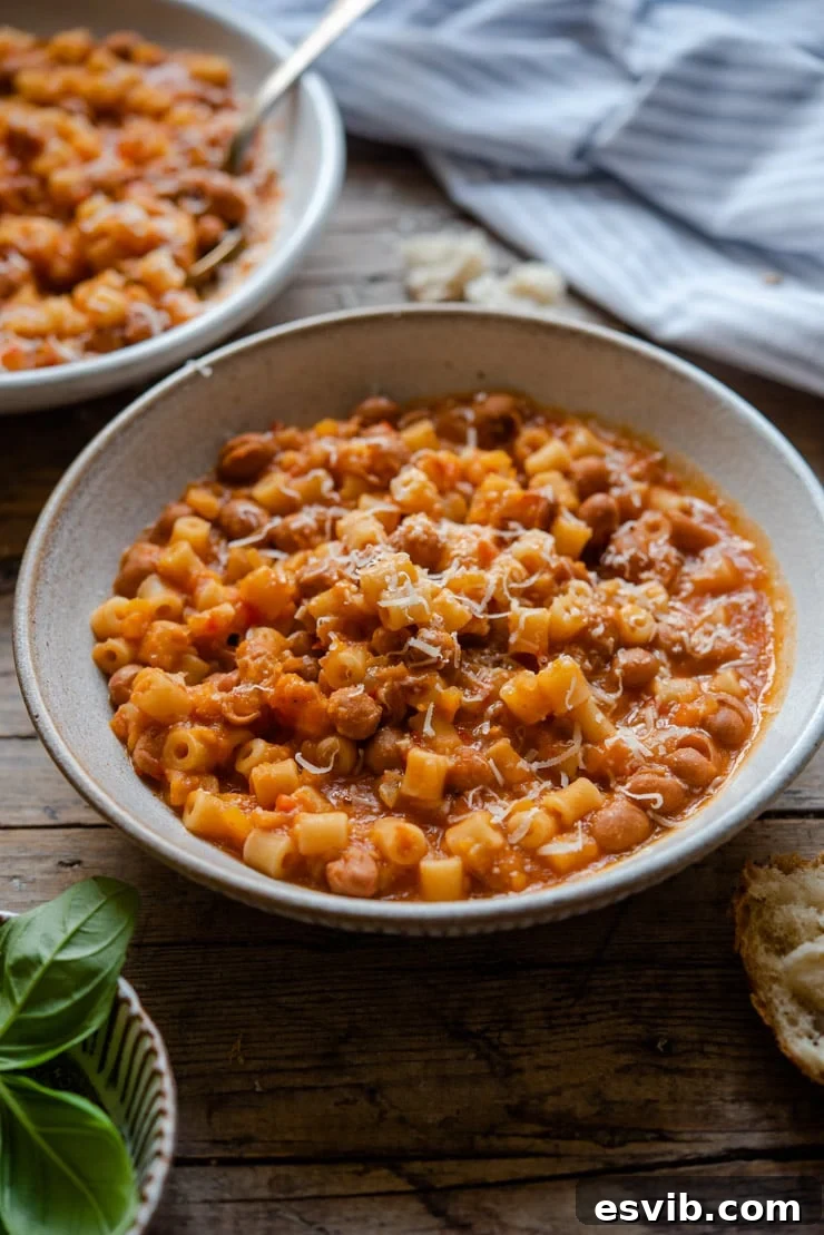 Pasta fagioli soup in a rustic bowl with crusty bread