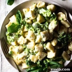A close up of ricotta gnocchi with parmesan sauce on a plate