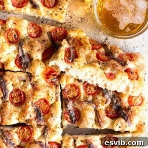 Close-up of the delicious Cherry Tomato Focaccia with Anchovies and Oregano.