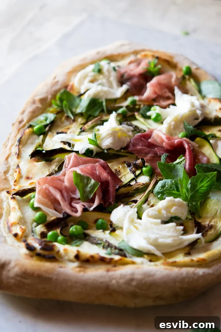 A close up of pizza with zucchini, asparagus and prosciutto A close up of pizza with zucchini, asparagus and prosciutto