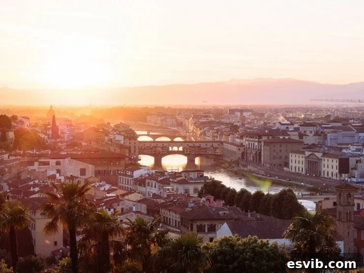A stunning panoramic photo of the city of Florence and the iconic Ponte Vecchio bathed in the warm glow of sunset, capturing the romantic essence of Italy.