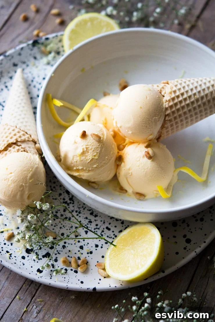 A refreshing serving of lemon ice cream in a bowl, accompanied by a crispy ice cream cone.