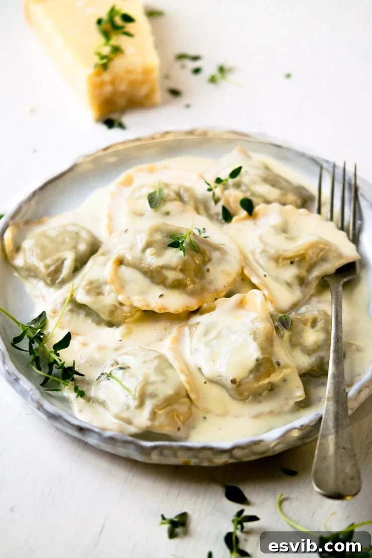 Close-up view of Stuffed Mushroom Ravioli with Parmesan Cheese on a Plate with a Fork