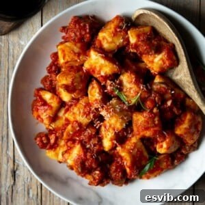 A square image of sausage ragu with ricotta gnocchi