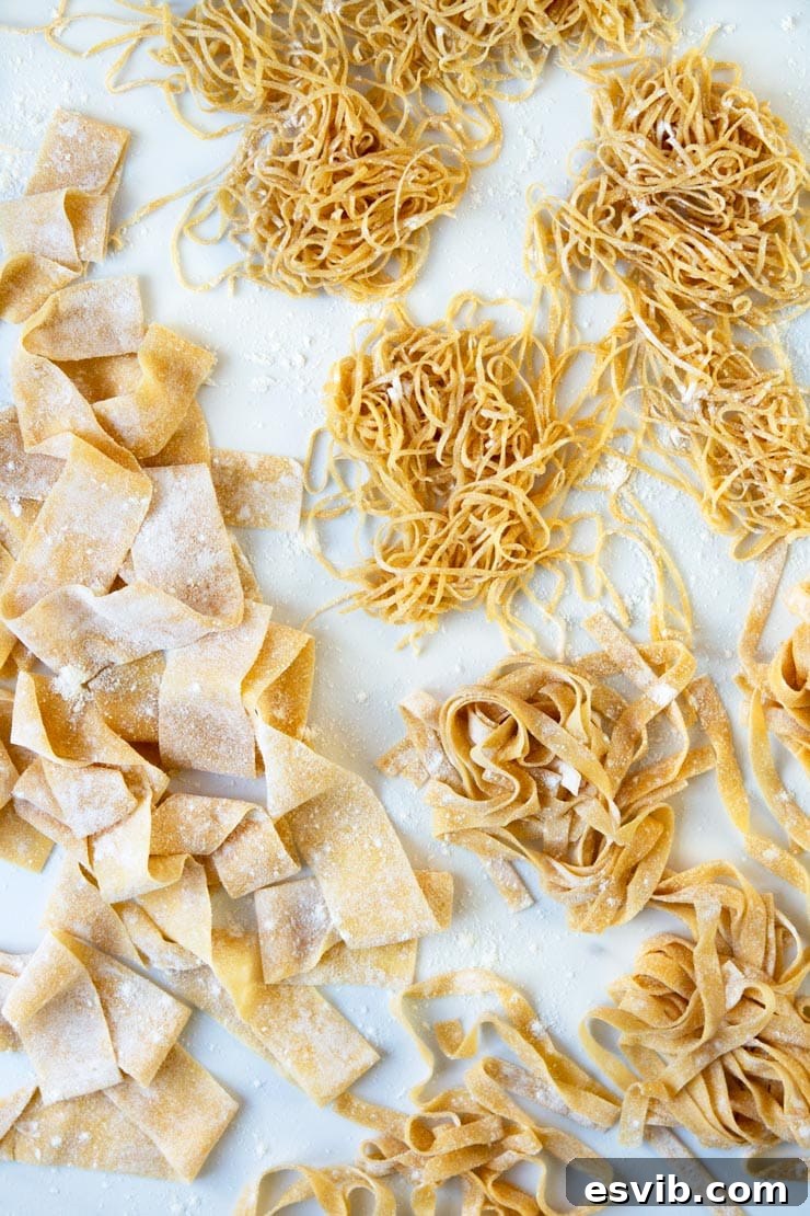 Homemade Pasta Dough. How to make easy homemade pasta dough from scratch. Make lasagne sheets, tagliatelle, pappardelle and so much more. Serve with your favourite pasta sauce for the ultimate comfort food meal. | Italian Pasta Recipes | Authentic Italian Pasta Recipes | #Insidetherustickitchen #pasta #Italian #Italianrecipes An overhead shot of different fresh pasta shapes made with homemade pasta dough, including tagliatelle and farfalle