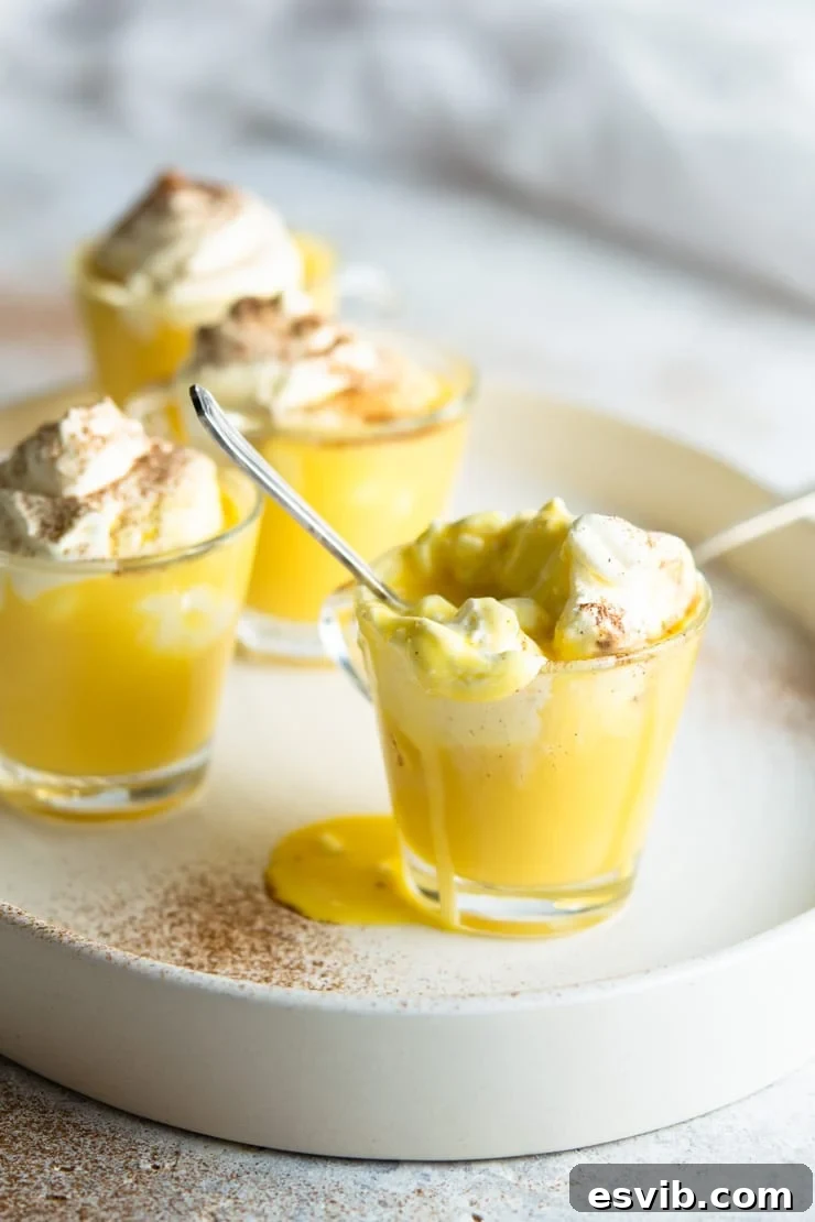 A close up of an espresso cup filled with bombardino eggnog liqueur and spilling over the edge