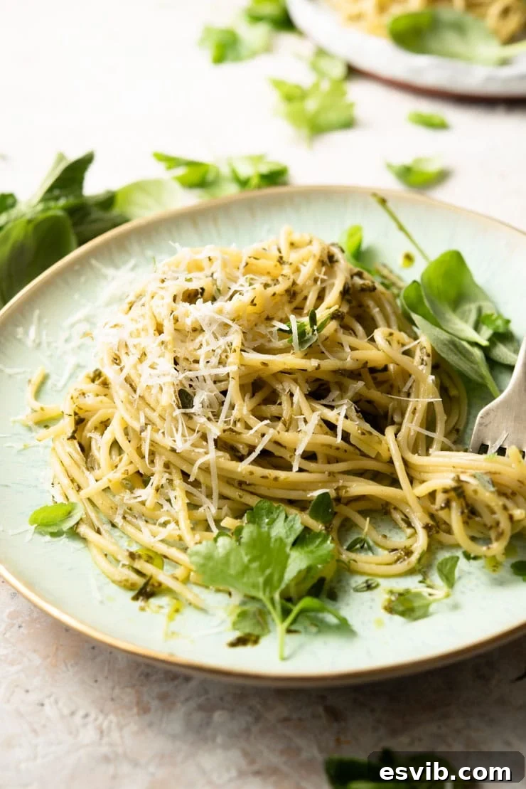 Delicious Herby Garlic Butter Pasta Sauce, perfect for a quick and flavorful meal. A side shot of spaghetti with garlic butter pasta sauce and fresh herbs, garnished with grated cheese