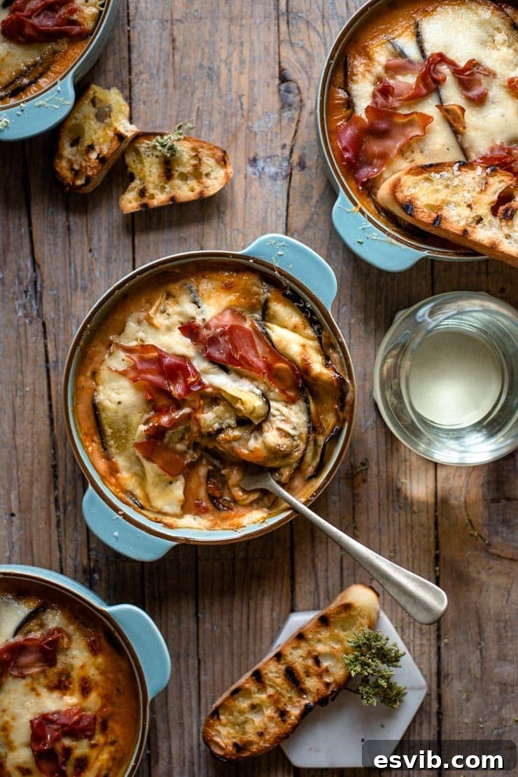 Baked Eggplant Lasagna Ready to Serve An overhead shot of eggplant lasagna in a blue dish with a fork, ready to be enjoyed.