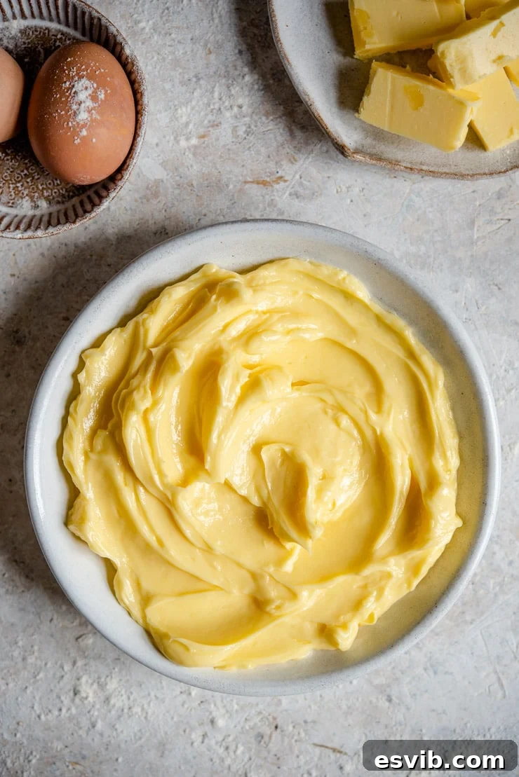 Softened Butter Ready for Baking An overhead shot of beautifully softened butter in a bowl, perfectly creamy and ready for baking, showcasing its ideal consistency.