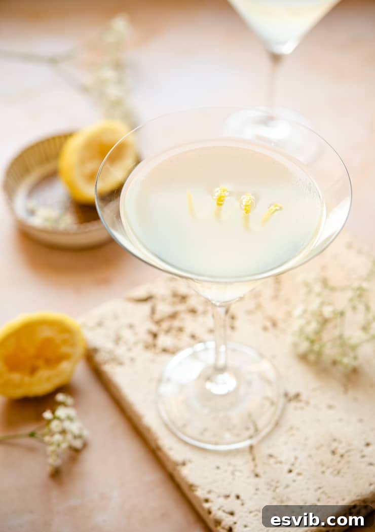 A beautifully presented Limoncello martini in a classic martini glass, garnished with a delicate spiral of lemon peel.