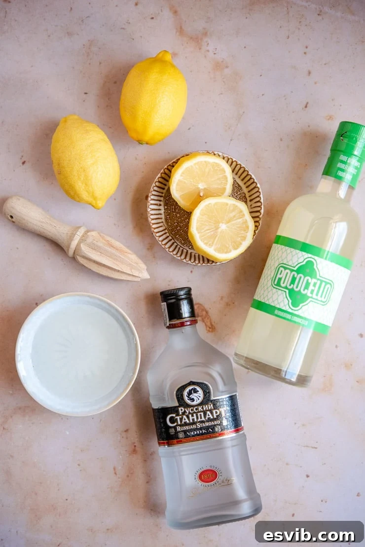A collection of the fresh and vibrant ingredients needed to prepare a delicious Limoncello martini, including lemons, a bottle of limoncello, vodka, and simple syrup.
